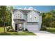 Charming two-story home with light blue siding, a front porch with rocking chairs, and a well-manicured lawn at 123 Moscato Ln, Summerville, SC 29485
