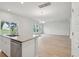 Bright, open-concept kitchen featuring white cabinets, granite countertops, and stainless appliances, adjacent to the living space at 123 Moscato Ln, Summerville, SC 29485