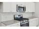Modern kitchen featuring white cabinets, granite countertops, stainless appliances, and subway tile backsplash for a stylish look at 123 Moscato Ln, Summerville, SC 29485