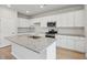 Bright kitchen features white cabinets, granite countertops, and stainless steel appliances, perfect for modern living at 123 Moscato Ln, Summerville, SC 29485