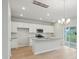 Bright kitchen featuring white cabinets, a spacious island, stainless appliances, and a sliding door to the backyard at 123 Moscato Ln, Summerville, SC 29485