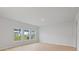 Bright living room featuring hardwood floors, three windows, and neutral paint, creating a warm and inviting space at 123 Moscato Ln, Summerville, SC 29485