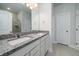 Bathroom with dual vanity, granite countertop, and large mirror at 125 Royal Cainhoy Way, Huger, SC 29450