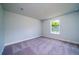 Bedroom with carpeted floor, neutral walls and a bright window at 125 Royal Cainhoy Way, Huger, SC 29450
