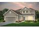 Charming two-story home with a manicured lawn and a two-car garage, offering classic curb appeal at 125 Royal Cainhoy Way, Huger, SC 29450