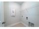 Bright laundry area with tile floors, upper shelving, and utility connections at 125 Royal Cainhoy Way, Huger, SC 29450