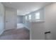 Upstairs loft area with carpeted floors and ample natural light from several windows at 125 Royal Cainhoy Way, Huger, SC 29450