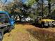 A blue truck and yellow truck parked in the yard at 1255 Remount Rd, North Charleston, SC 29406
