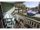 Balcony with cushioned seating, views of the parking area, and tropical landscaping at 1300 Ocean Blvd # 139, Isle of Palms, SC 29451