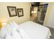 Bedroom with walk-in closet, palm tree art, and a television at 1300 Ocean Blvd # 139, Isle of Palms, SC 29451