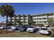 Multi-story condo building with balconies and well-maintained parking area and landscaping at 1300 Ocean Blvd # 139, Isle of Palms, SC 29451