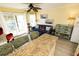 Living room with couch, ceiling fan and balcony access at 1300 Ocean Blvd # 139, Isle of Palms, SC 29451