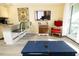 Living room view shows the flat screen TV, breakfast bar, comfortable chair, and a peek at the ocean at 1300 Ocean Blvd # 139, Isle of Palms, SC 29451