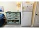 Living room with a distressed dresser, full size refrigerator, and beachy decor at 1300 Ocean Blvd # 139, Isle of Palms, SC 29451