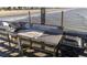 Fishing station on pier featuring a sink, cutting board, and utensil holders with a black trashcan on a sunny day at 1300 Ocean Blvd # 139, Isle of Palms, SC 29451