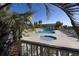 Inviting pool area with lounge chairs and hot tub, surrounded by lush tropical palm trees, perfect for relaxation at 1300 Ocean Blvd # 139, Isle of Palms, SC 29451