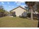 Backyard view shows the screened porch, siding, tree, and fence showcasing the outdoor space at 1309 Basketweaver Way, Hanahan, SC 29410