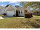 Inviting single-Gathering home featuring a manicured front yard, neutral siding, and a two-car garage at 1309 Basketweaver Way, Hanahan, SC 29410