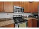 The kitchen boasts a stainless steel gas range with stainless steel microwave above at 1309 Basketweaver Way, Hanahan, SC 29410