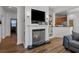 Living area featuring a fireplace, TV, and open access to the kitchen at 1309 Basketweaver Way, Hanahan, SC 29410