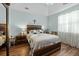 Spacious main bedroom with tray ceiling, wood flooring, and large bed at 1309 Basketweaver Way, Hanahan, SC 29410