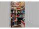 Organized pantry with shelves stocked with household items, bins, and towels providing ample storage at 1309 Basketweaver Way, Hanahan, SC 29410