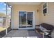 The cozy screened porch features a wicker sofa with cushions and a sliding door to the home interior at 1309 Basketweaver Way, Hanahan, SC 29410