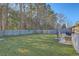 Spacious backyard featuring a well-maintained lawn, patio, seating and privacy fencing at 131 Kennington Dr, Goose Creek, SC 29445