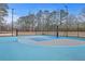 Outdoor basketball court with hoops and a fence surrounded by trees, perfect for recreational games at 131 Kennington Dr, Goose Creek, SC 29445
