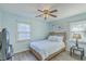 Cozy bedroom featuring two windows for natural light, a ceiling fan, and neutral walls at 131 Kennington Dr, Goose Creek, SC 29445