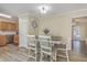 Dining area with a wooden table, upholstered chairs, and a view into the adjacent living room at 131 Kennington Dr, Goose Creek, SC 29445