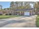 Charming brick home with a well-manicured lawn and a paved driveway leading to the garage at 131 Kennington Dr, Goose Creek, SC 29445
