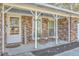 Inviting covered front porch featuring a seating area with comfortable chairs and decorative plants at 131 Kennington Dr, Goose Creek, SC 29445