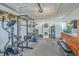 A multi-purpose garage space with gym equipment, laundry, and cabinetry for a functional and organized area at 131 Kennington Dr, Goose Creek, SC 29445