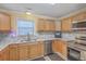 Updated kitchen with stainless steel appliances, granite countertops, and light wood cabinetry at 131 Kennington Dr, Goose Creek, SC 29445