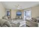 Spacious living room featuring plush sofas, a ceiling fan, and sliding glass doors to the backyard at 131 Kennington Dr, Goose Creek, SC 29445