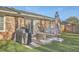 Cozy patio area with a grill, outdoor furniture, and an umbrella for shade and relaxing at 131 Kennington Dr, Goose Creek, SC 29445
