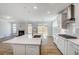 Open kitchen featuring stainless appliances, center island, view to fireplace and backyard at 134 Palfrey Dr, Ridgeville, SC 29472