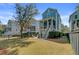 Large backyard with a patio area, surrounded by lush greenery, offering a private outdoor space at 1450 Eutaw Battalion Dr, Charleston, SC 29412