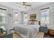 Bright bedroom with white shiplap walls, ceiling fan, and a door leading to the outside deck at 1450 Eutaw Battalion Dr, Charleston, SC 29412