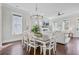 Open-concept dining room flowing into the living room with fireplace, hardwood floors, and natural light at 1450 Eutaw Battalion Dr, Charleston, SC 29412