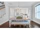 Dining area showcasing a farmhouse table, decorative chandelier, and seamless flow into the kitchen at 1450 Eutaw Battalion Dr, Charleston, SC 29412