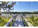 Scenic boardwalk leading to a private dock, surrounded by marsh grasses and lowcountry charm at 1450 Eutaw Battalion Dr, Charleston, SC 29412