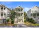 Beautiful home featuring double front porches, stairs and a well-manicured lawn at 1450 Eutaw Battalion Dr, Charleston, SC 29412