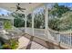 A welcoming front porch with cozy seating, white railings, and a peaceful outdoor view at 1450 Eutaw Battalion Dr, Charleston, SC 29412