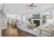 Open-concept living room with fireplace, hardwood floors, and abundant natural light at 1450 Eutaw Battalion Dr, Charleston, SC 29412