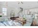 Bright living room featuring hardwood floors, neutral walls, and comfortable sofas near stairs at 1450 Eutaw Battalion Dr, Charleston, SC 29412