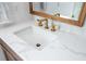 Close-up of bathroom sink with marble countertop and gold fixtures at 1450 Eutaw Battalion Dr, Charleston, SC 29412