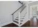 Staircase with dark wood treads and white risers and white trim at 1450 Eutaw Battalion Dr, Charleston, SC 29412