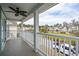 Inviting balcony featuring white railings and a ceiling fan, offering scenic neighborhood views at 1651 Valley Oak Rd, Johns Island, SC 29455